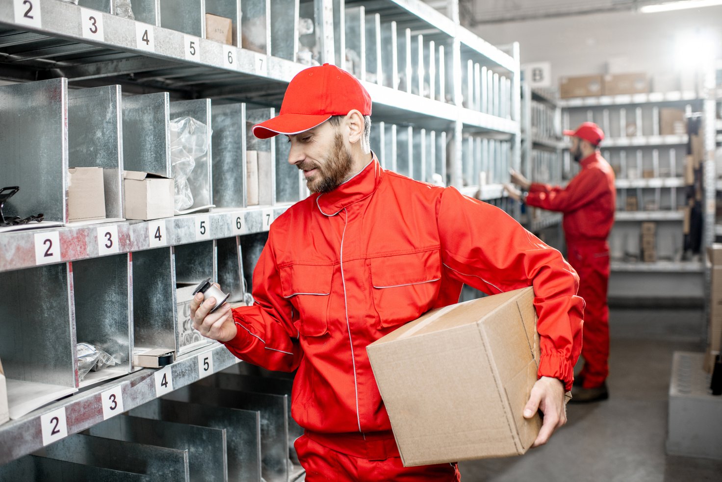 Man Working at the Warehouse with Auto Parts